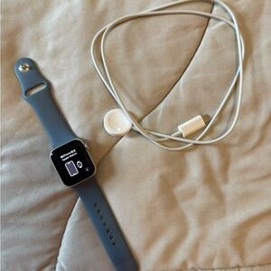 Apple Watch SE 2 with blue band and charger